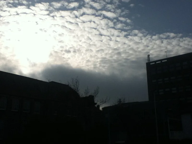 Urban rooftop silhouette with dramatic sky — fiction set in England by David Moran
