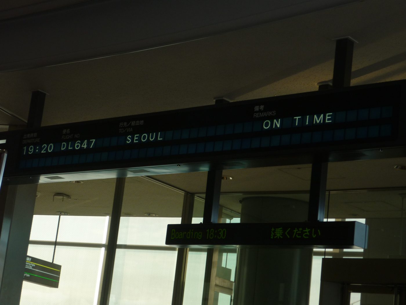 Airport departure board showing on time to Seoul
